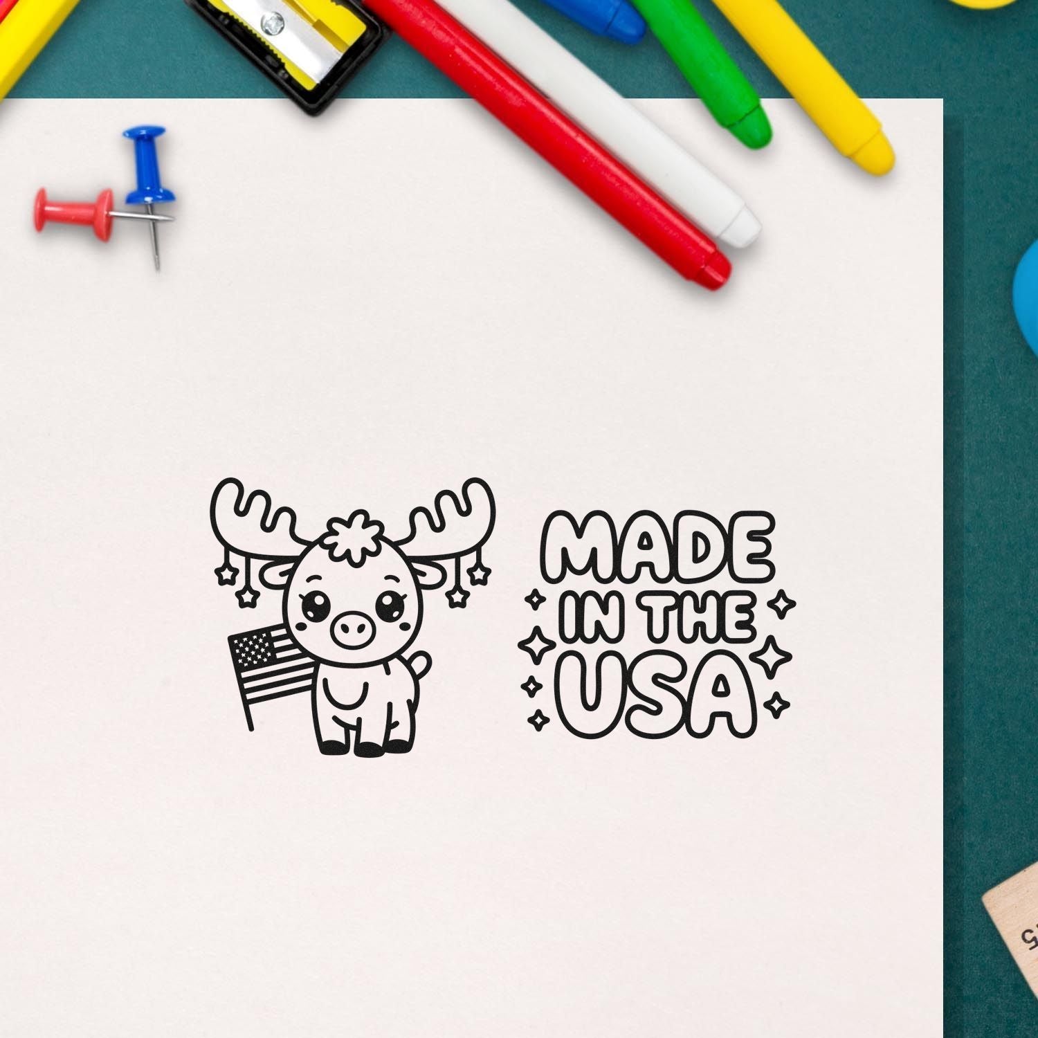 Made in the USA rubber stamp design with a cute moose and American flag, displayed on paper with colorful markers.