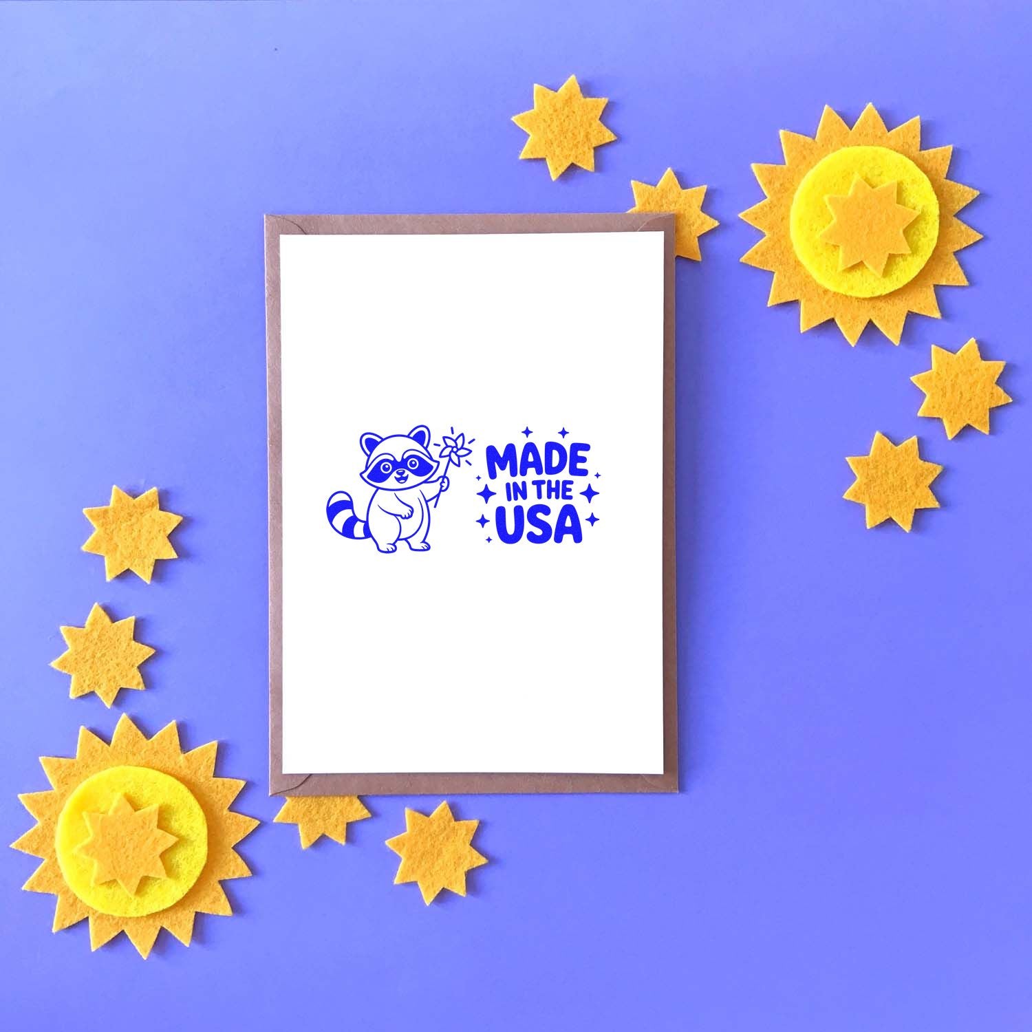 Made in the USA raccoon rubber stamp on greeting card with star accents, showcasing patriotic handmade craft design.