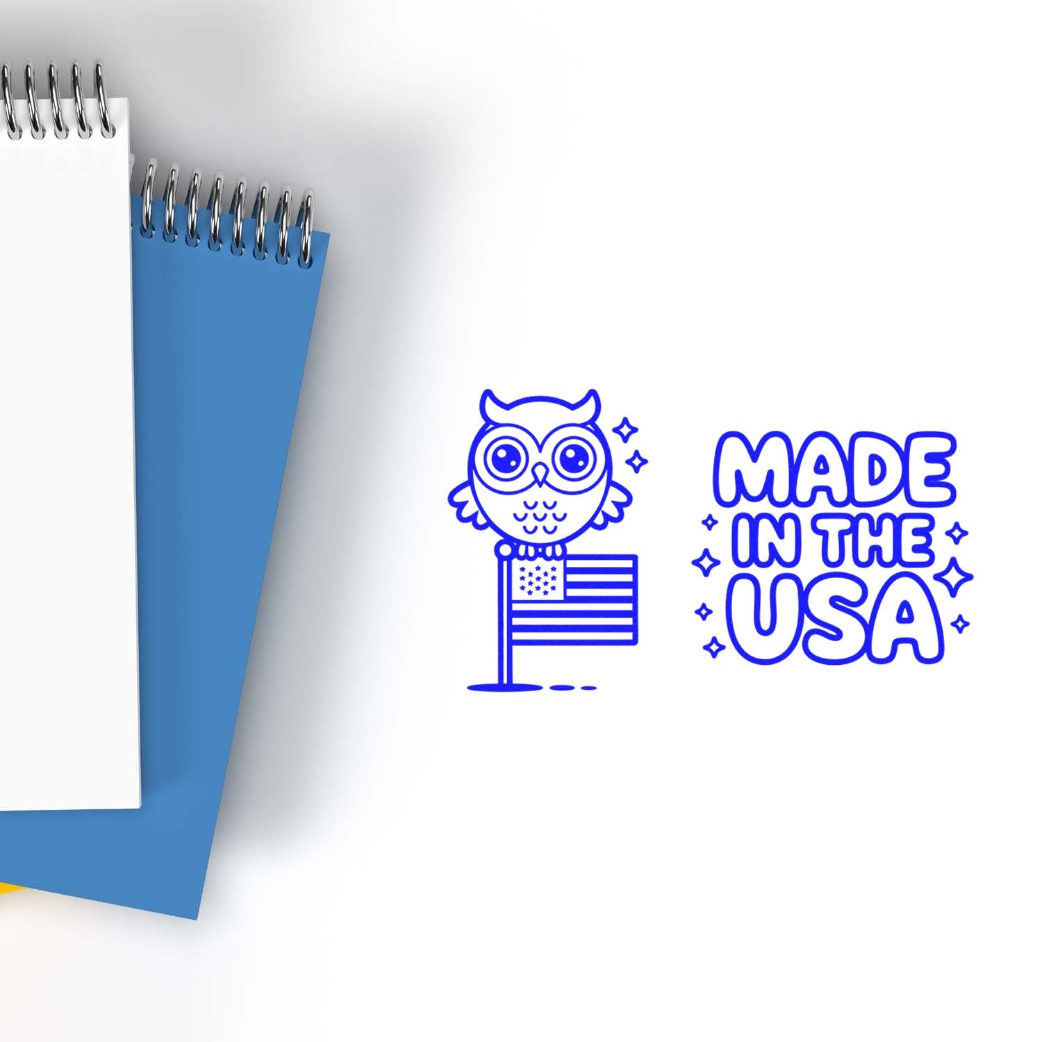 Made in USA owl rubber stamp design with patriotic flag icon, shown beside spiral notebooks for custom stationery branding.