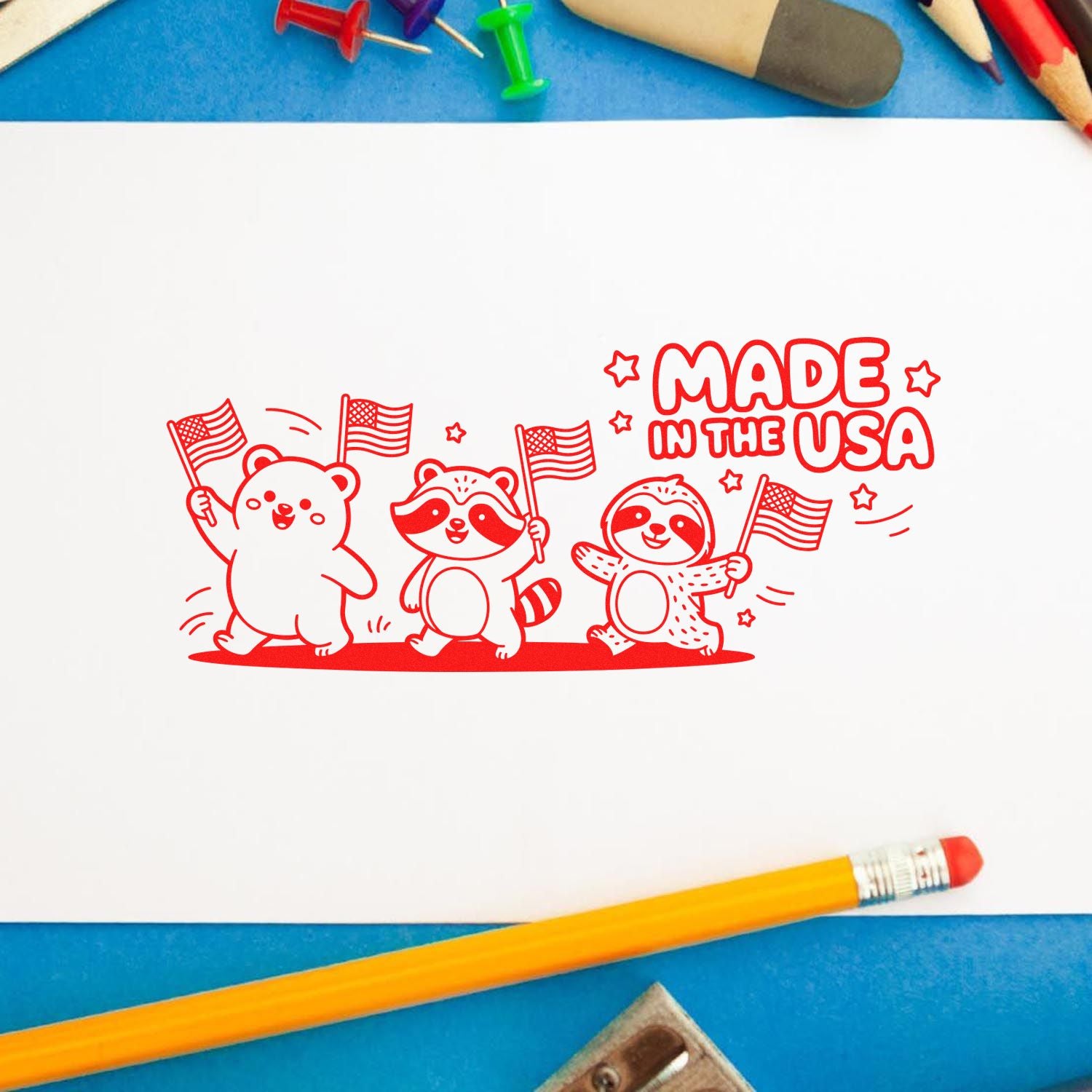 Red Made in the USA rubber stamp design featuring cute patriotic bear, raccoon, and sloth holding American flags.