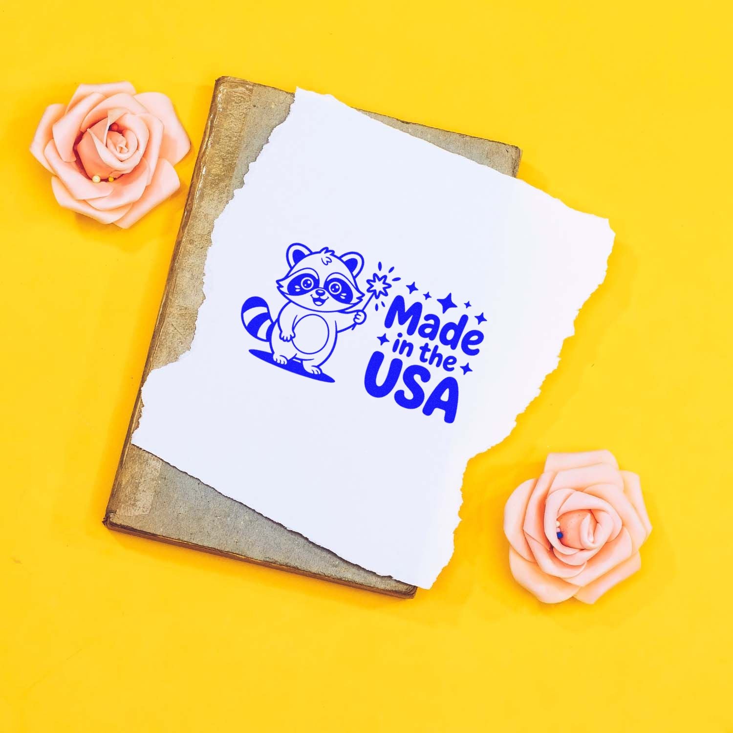 Made in the USA rubber stamp on torn paper with raccoon mascot, ideal for custom packaging, crafts, and small business branding.