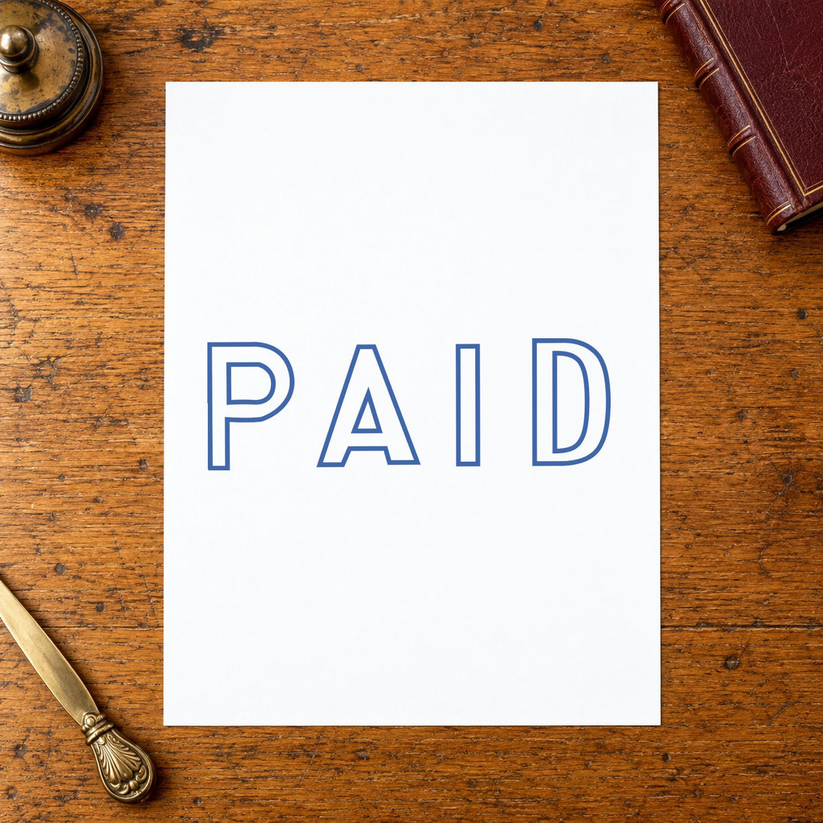 "Paid" stamp impression made with pre-inked Xstamper 1005