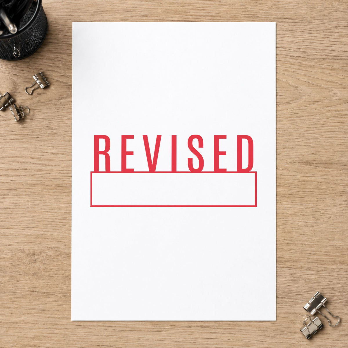 "Revised" imprint stamped on a document with the Xstamper Revised Stamp