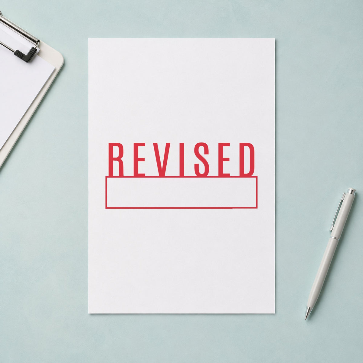 Marking a page "Revised" with the Xstamper Revised Stamp
