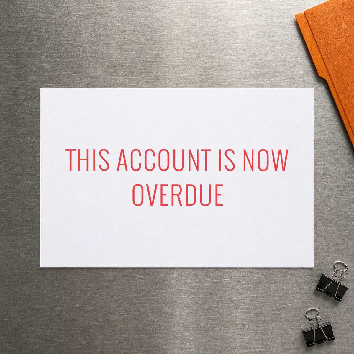"This account is now overdue" mark added to paperwork with a pre-inked Xstamper stamp