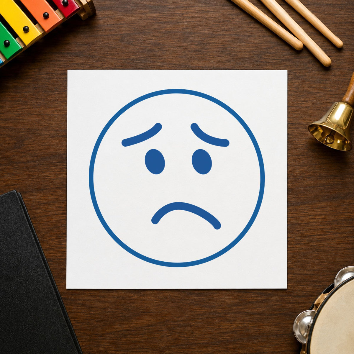 "Frown face" stamp impression made with pre-inked Xstamper 11305