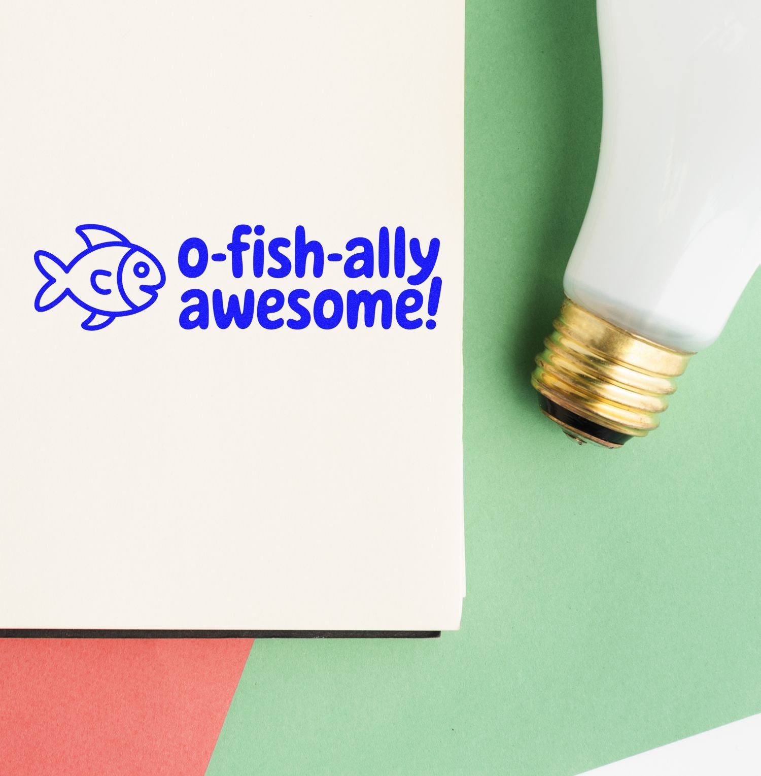 Fish rubber stamp impression reading o-fish-ally awesome! with stamp tool for playful stationery and craft projects.