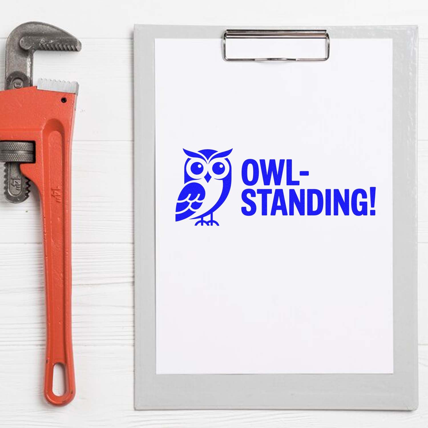 Blue owl-standing custom rubber stamp proof on clipboard, ideal for handyman or workshop branding.