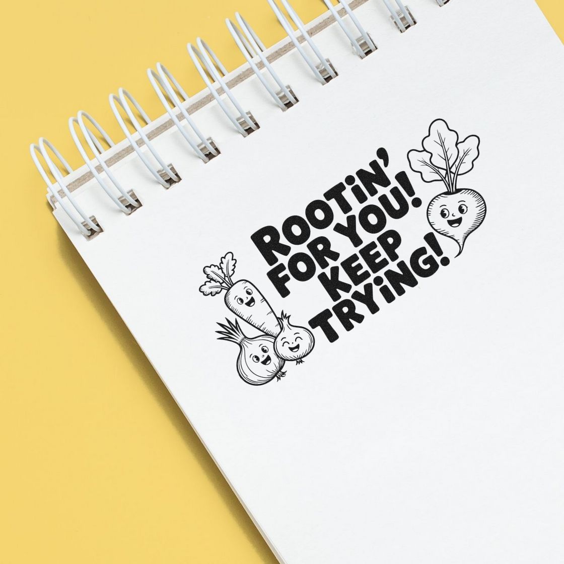 Motivational rubber stamp design with Rootin for you! Keep trying! and smiling vegetable illustrations on a notebook page.