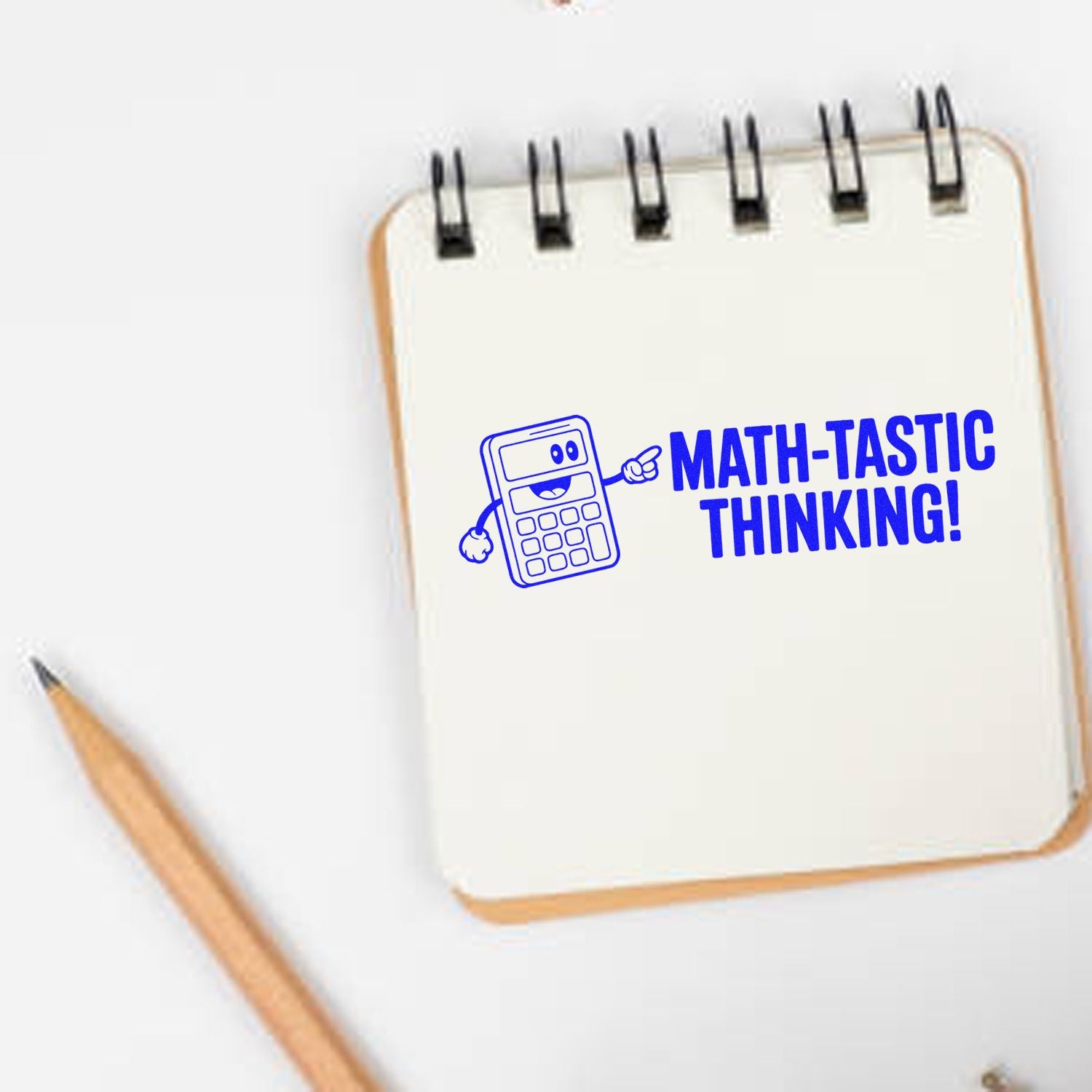 Math-tastic Thinking rubber stamp on notebook, featuring calculator graphic for classroom math encouragement.