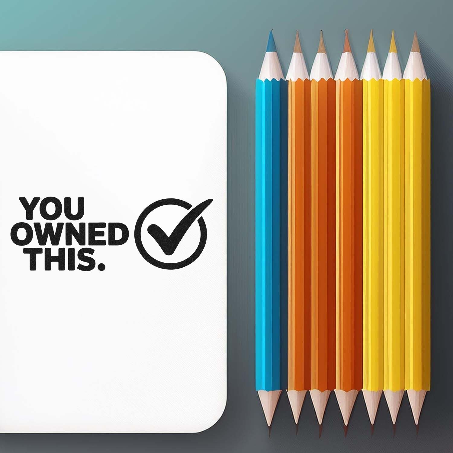Custom rubber stamp reading You Owned This with checkmark for personalized ownership marking on colored pencils.
