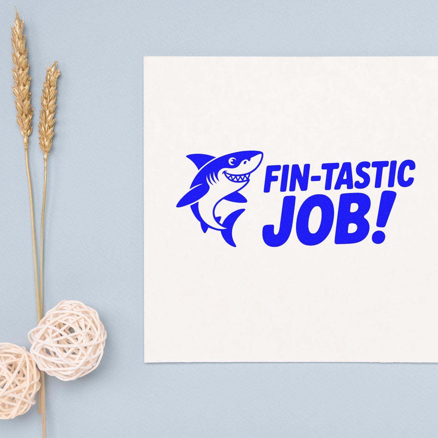 Shark-themed custom rubber stamp with FIN-TASTIC JOB! text in blue on white paper.