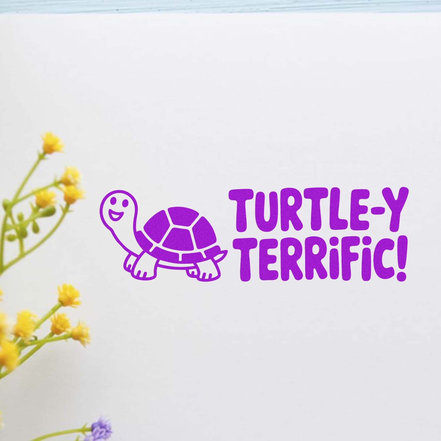 Purple turtle rubber stamp with Turtle-y Terrific! text on paper, perfect for fun card making and scrapbook crafts.