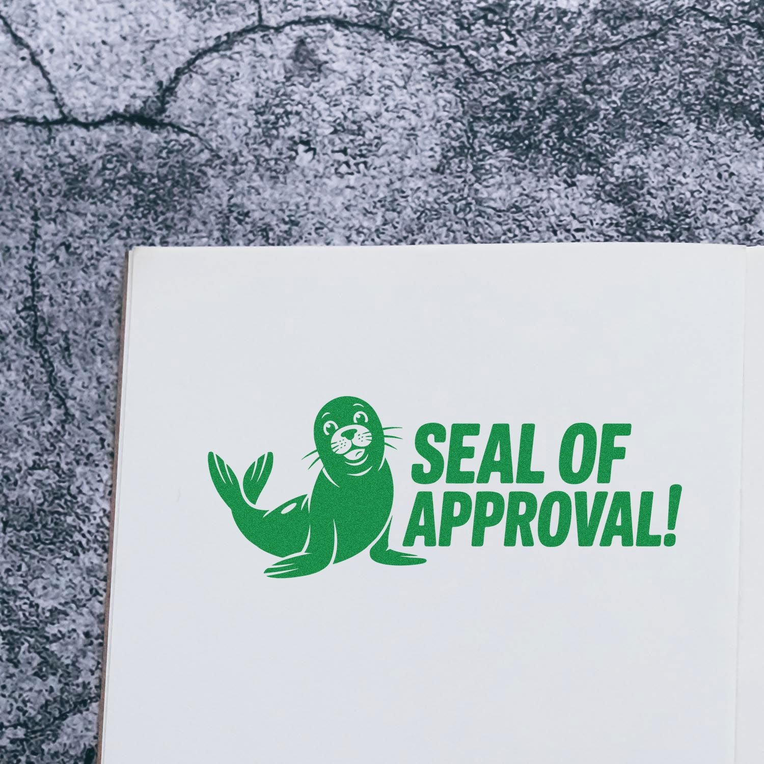 Green Seal of Approval rubber stamp imprint with seal illustration on white paper for packaging and document approval.