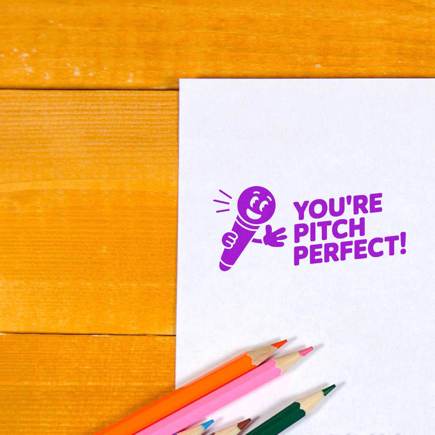 Purple rubber stamp design reading Youre Pitch Perfect! with microphone icon on paper, ideal for custom craft stamps.