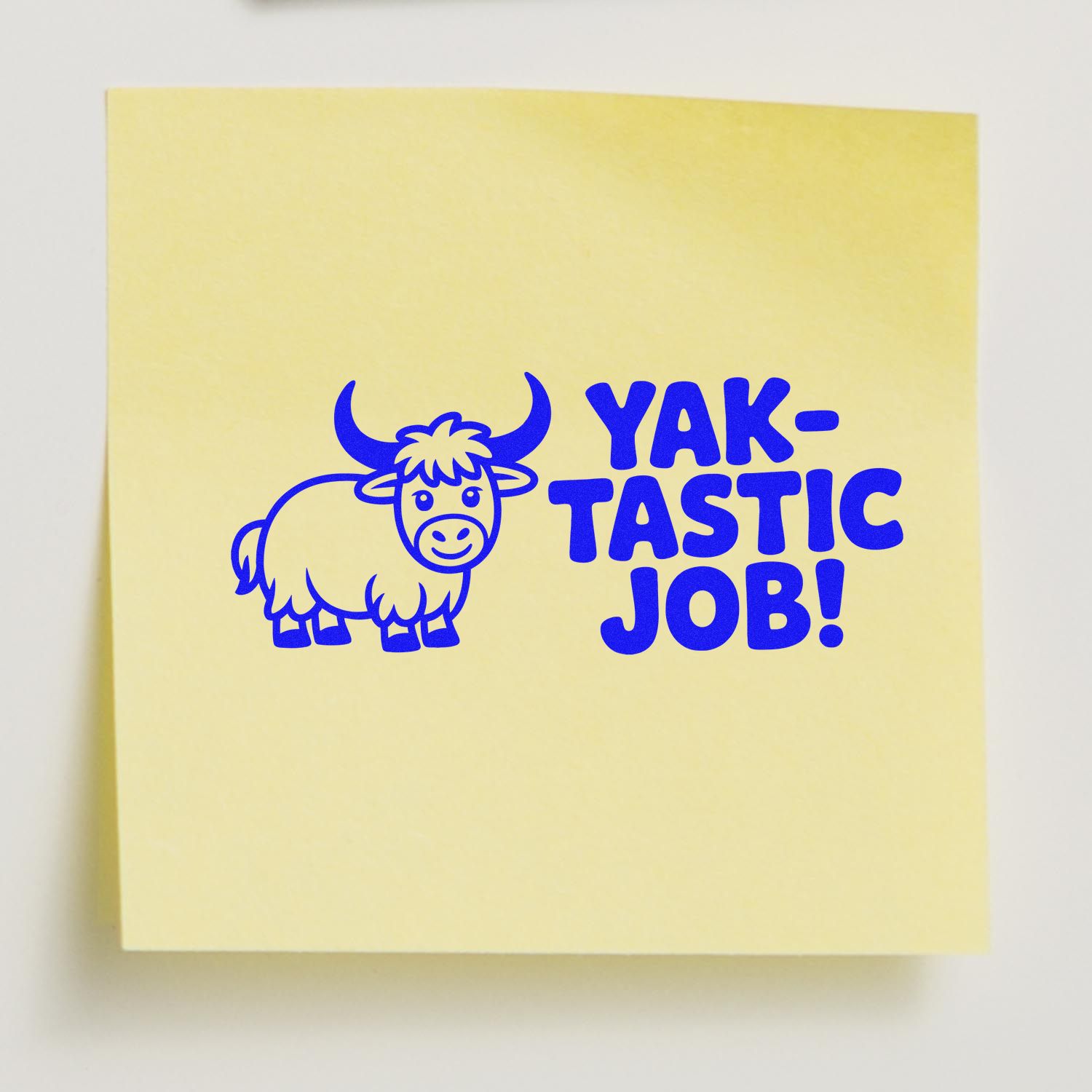 Yak-tastic Job! blue rubber stamp with cartoon yak on a yellow sticky note, ideal for teacher reward and encouragement.