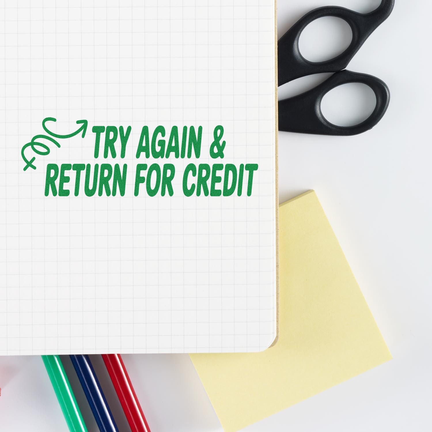 Try Again & Return for Credit rubber stamp design on notebook page with scissors and pens