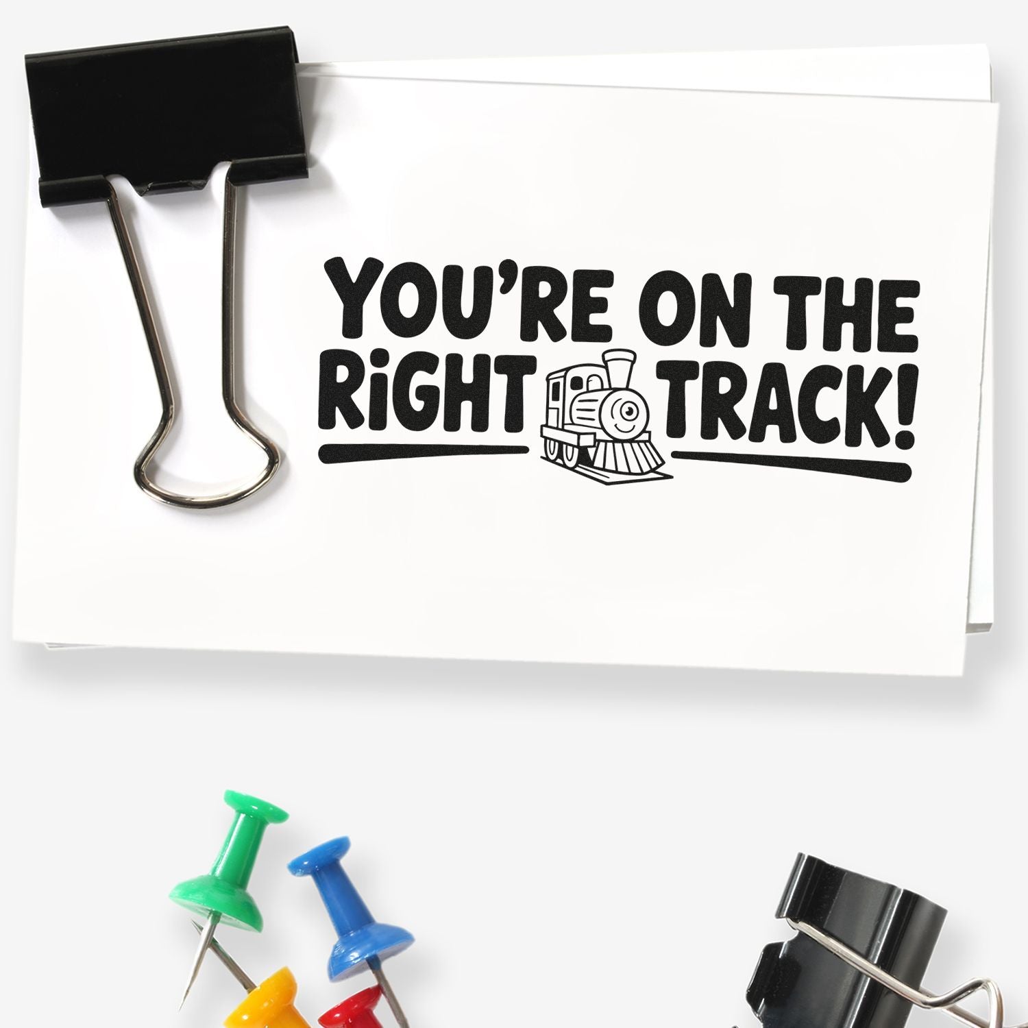 Train-themed rubber stamp imprint reading Youre on the right track! for classroom encouragement, rewards, or office use.