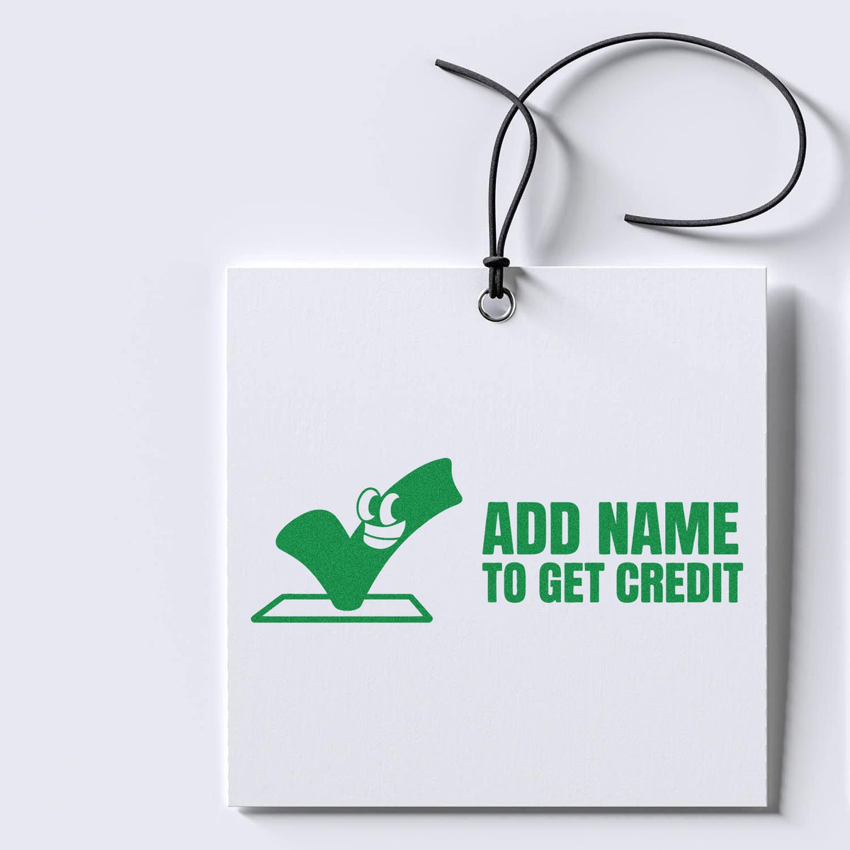 Custom rubber stamp design with green imprint reading Add Name to Get Credit on a white hanging tag.