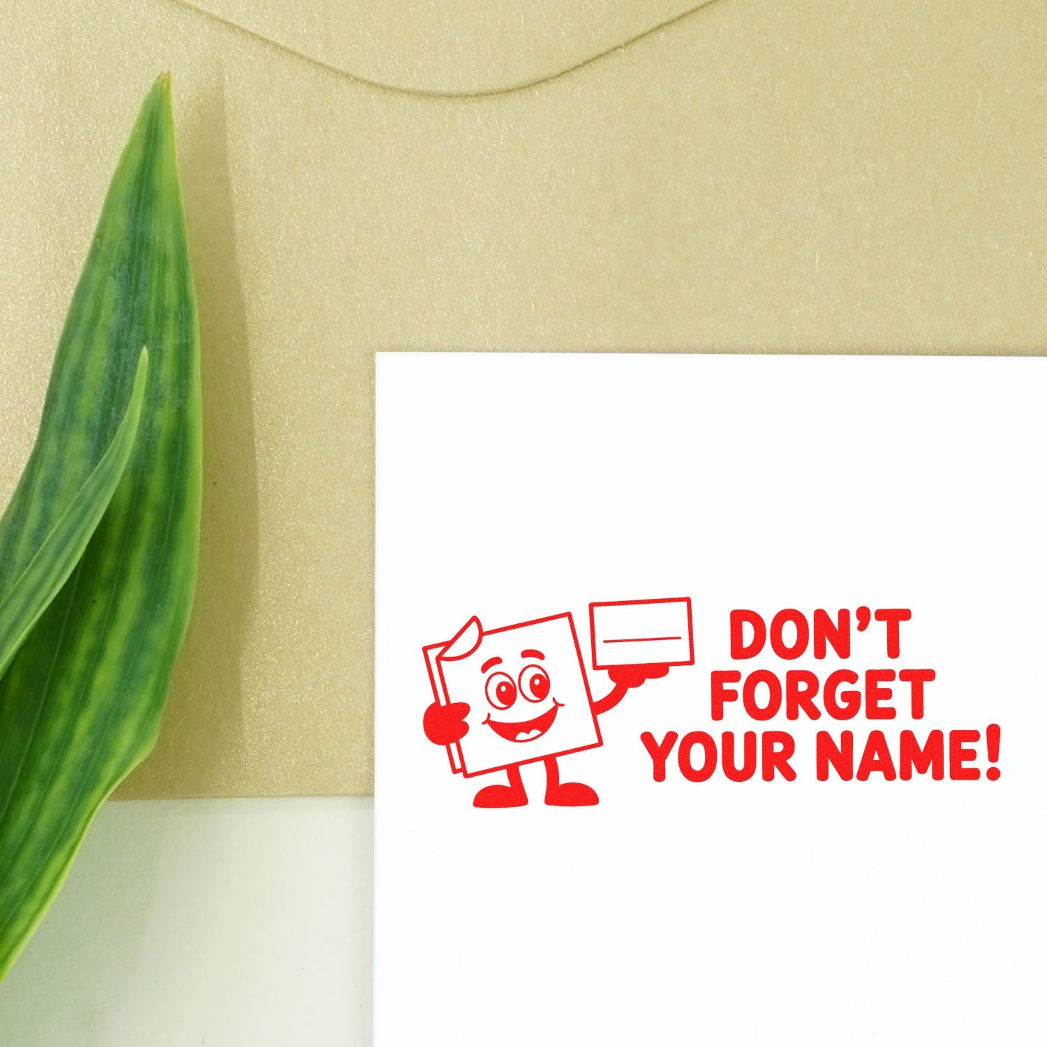 Red rubber stamp imprint reading Dont Forget Your Name! for custom name stamps, school supplies, and return-address labeling.