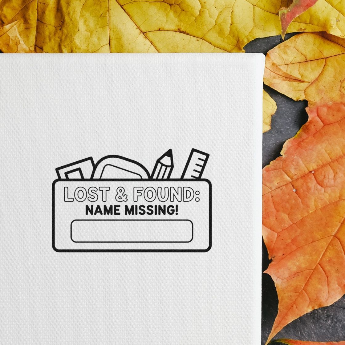 Lost and Found name missing rubber stamp design for school or office labels on white paper with fall leaves background.