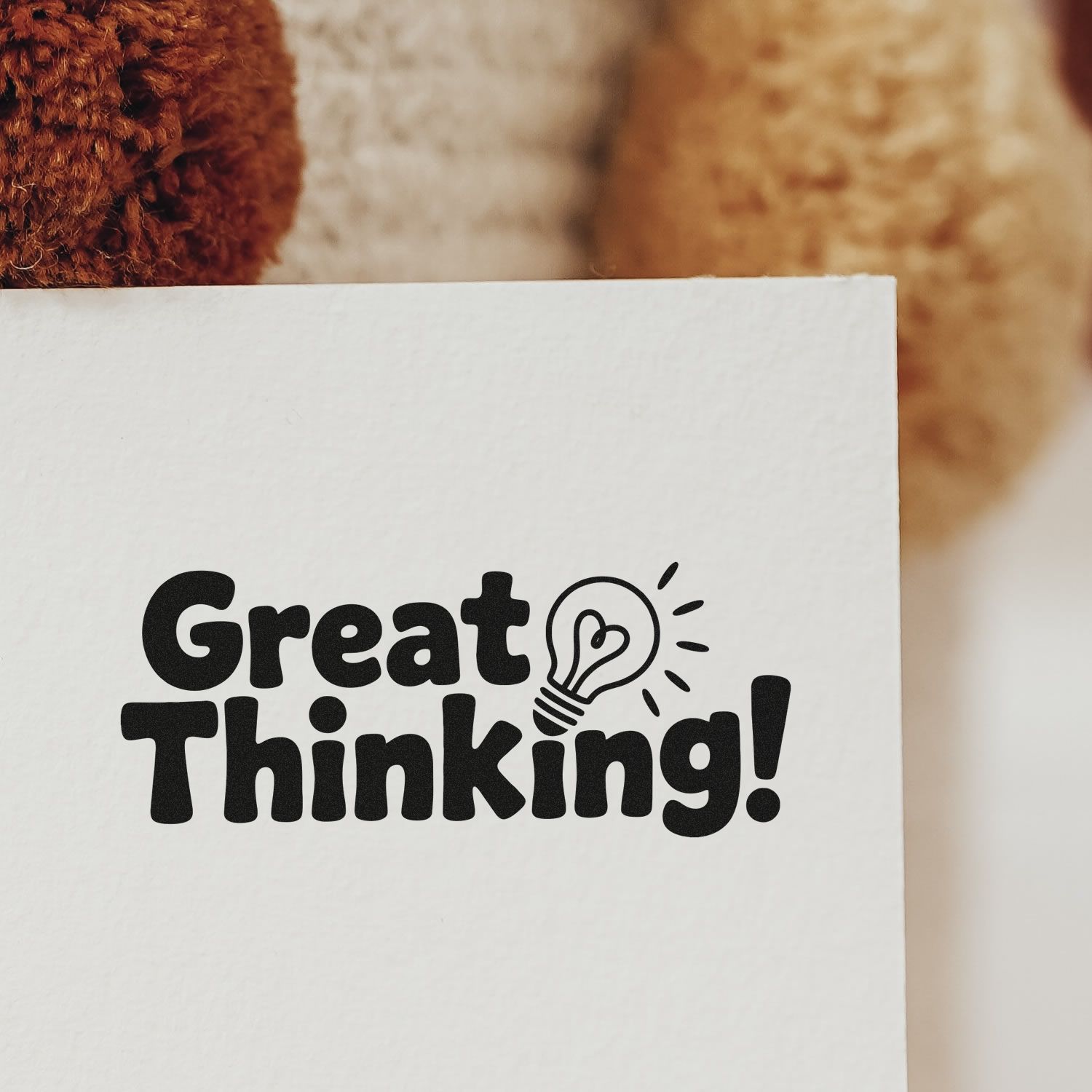 Great Thinking! rubber stamp design on white paper with lightbulb icon for creative notes and branding.