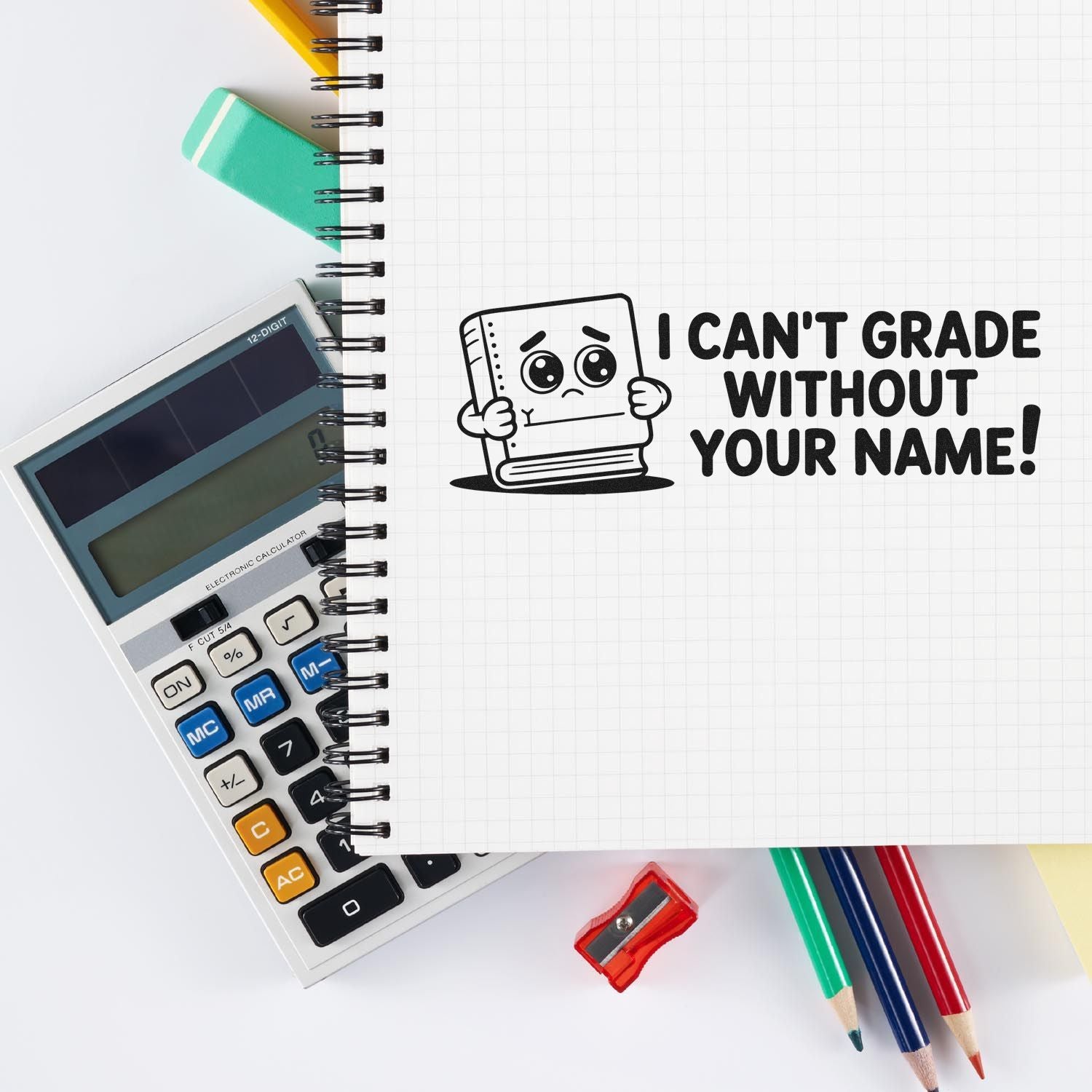 Teacher rubber stamp with I cant grade without your name! message on notebook beside calculator and pencils.