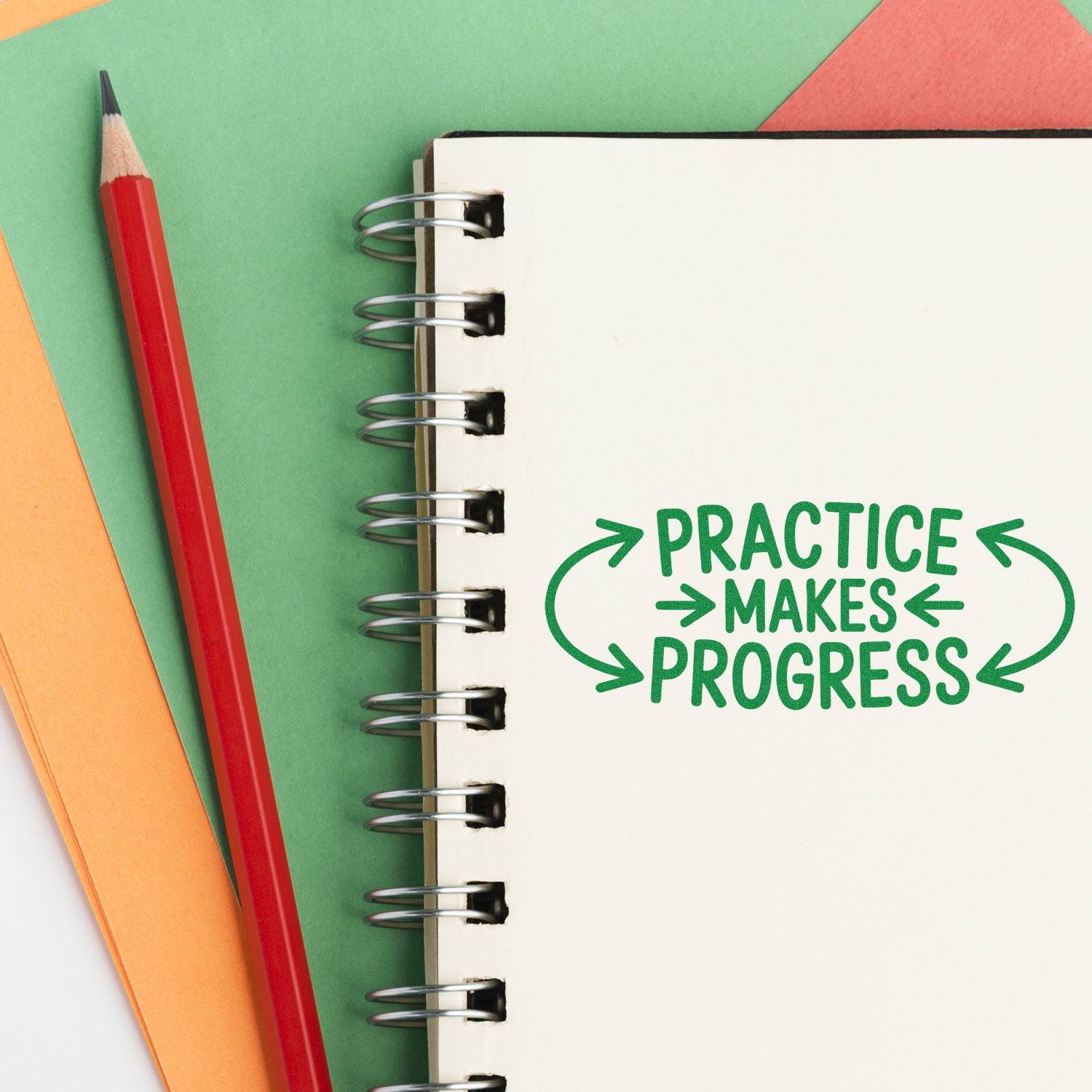 Motivational rubber stamp Practice Makes Progress on a notebook, perfect for planners, teachers, and craft stationery.