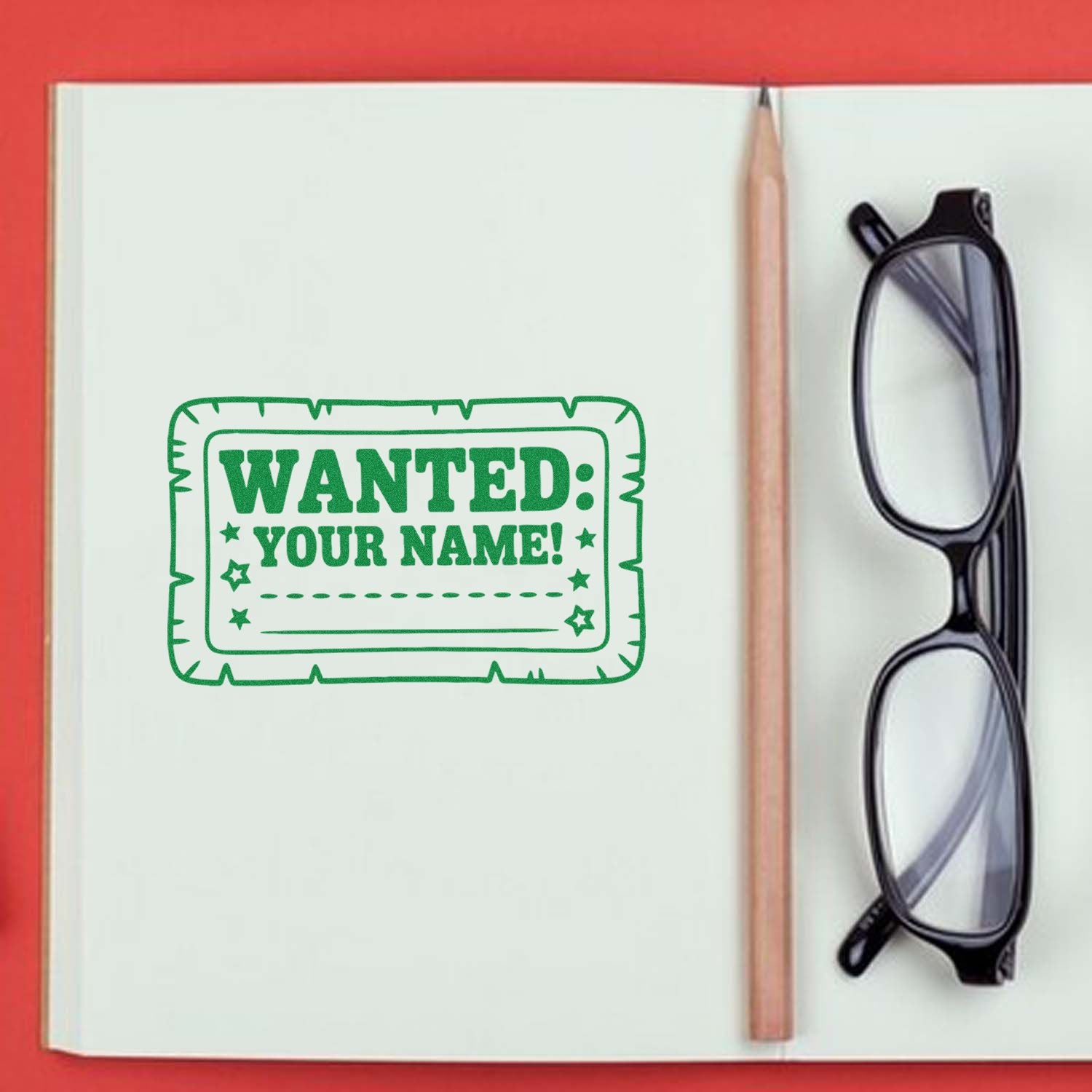 Custom rubber stamp design reading WANTED: YOUR NAME for personalized notebooks, planners, and school stationery.