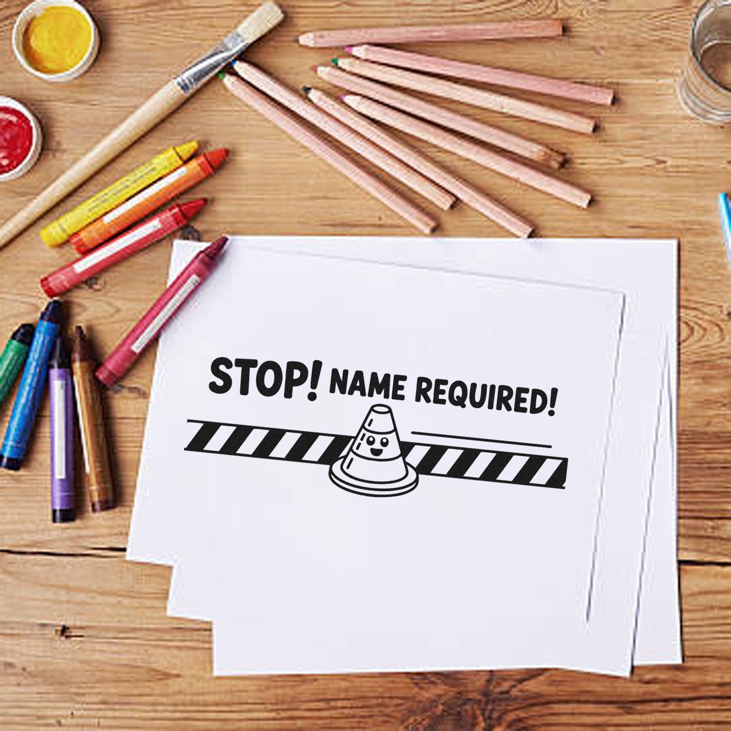 Rubber stamp design reading Stop! Name Required! with cone graphic, ideal for marking school papers and classroom assignments.