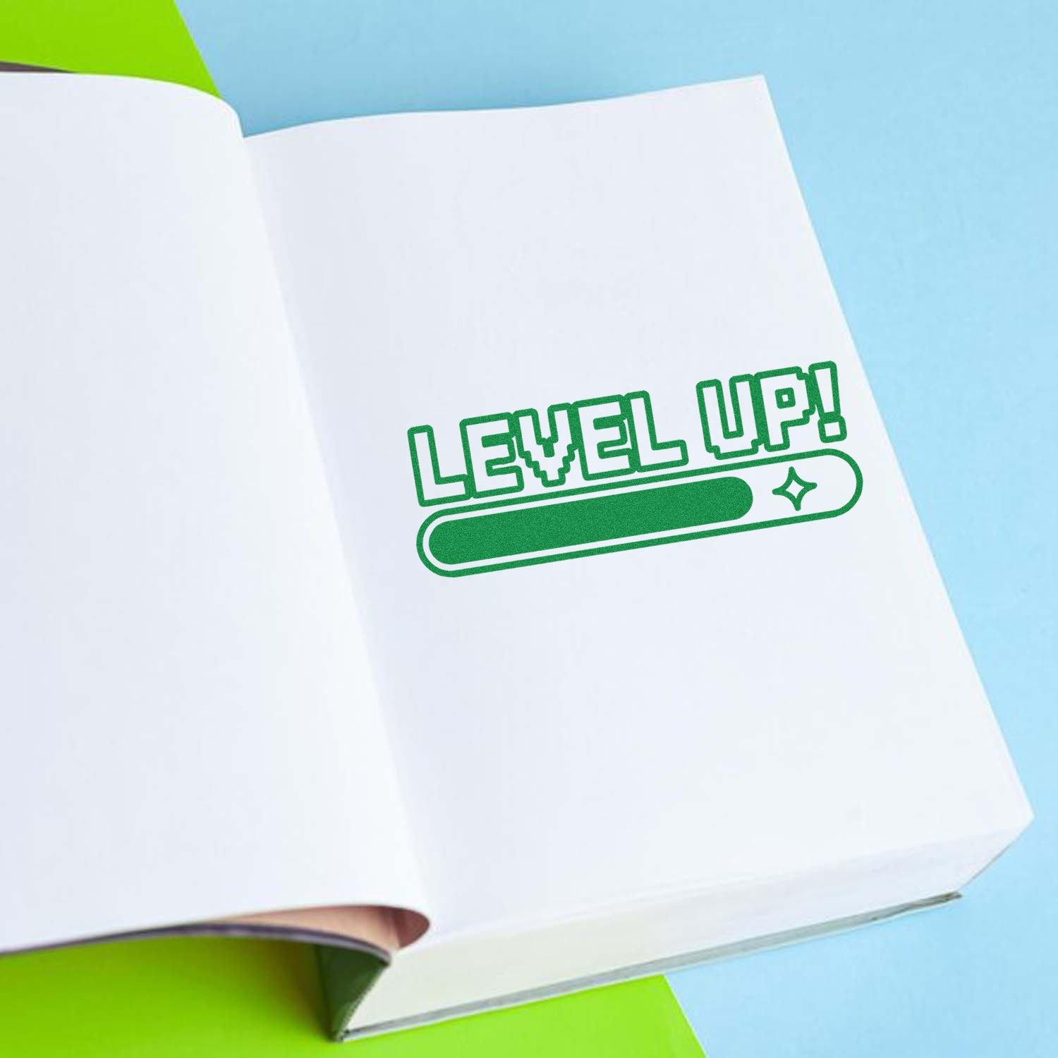 Green Level Up custom rubber stamp on an open notebook page for motivational branding and planner use.