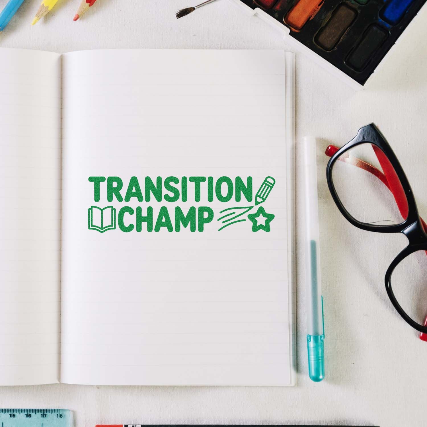 Transition Champ rubber stamp design on notebook, with school supplies and glasses for back-to-school classroom use.