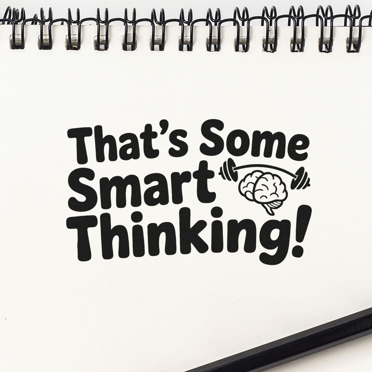 Rubber stamp design reading Thats Some Smart Thinking! with brain and dumbbell icon on a notebook page.