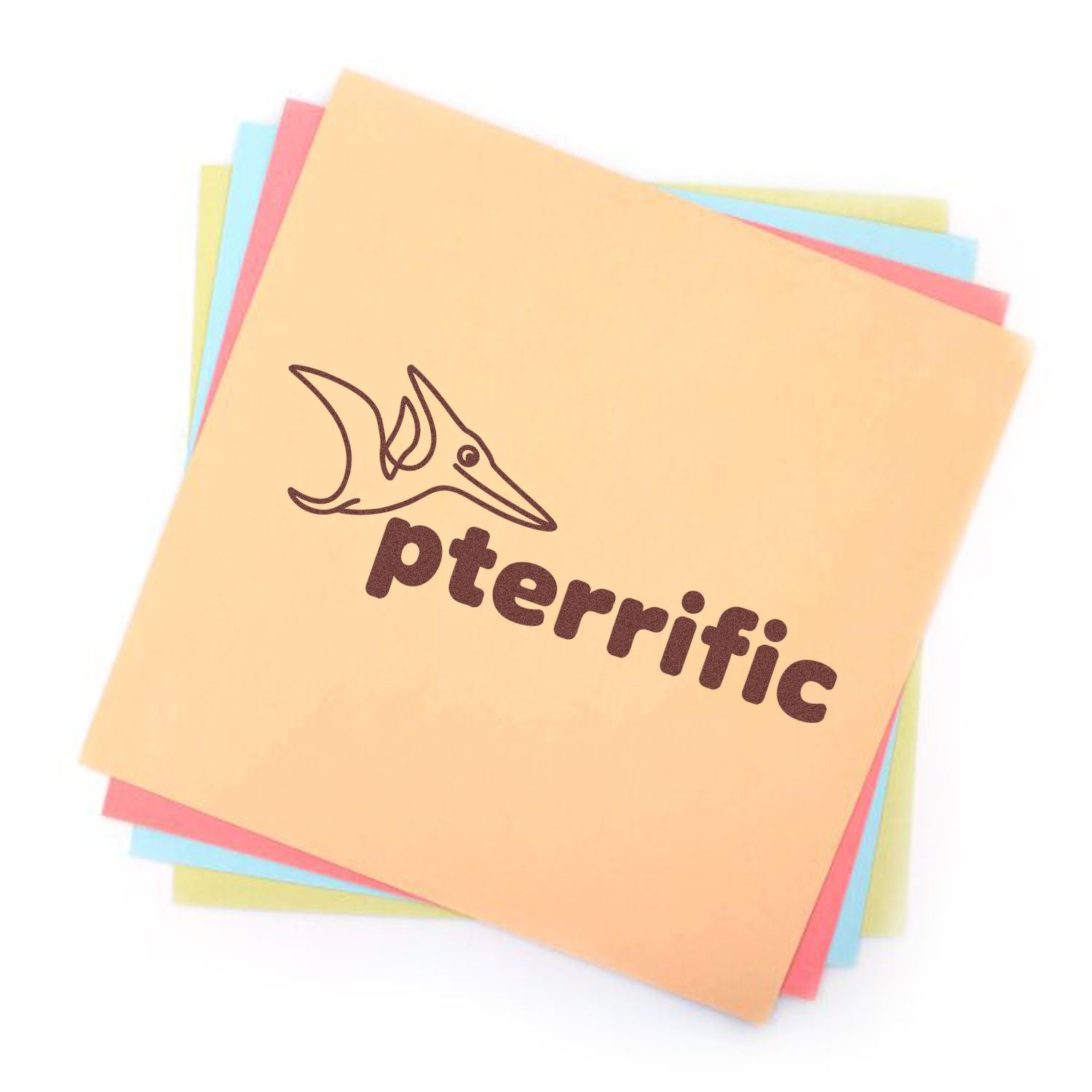 Pterific rubber stamp design with pterodactyl logo on stacked pastel paper sheets for custom branding.