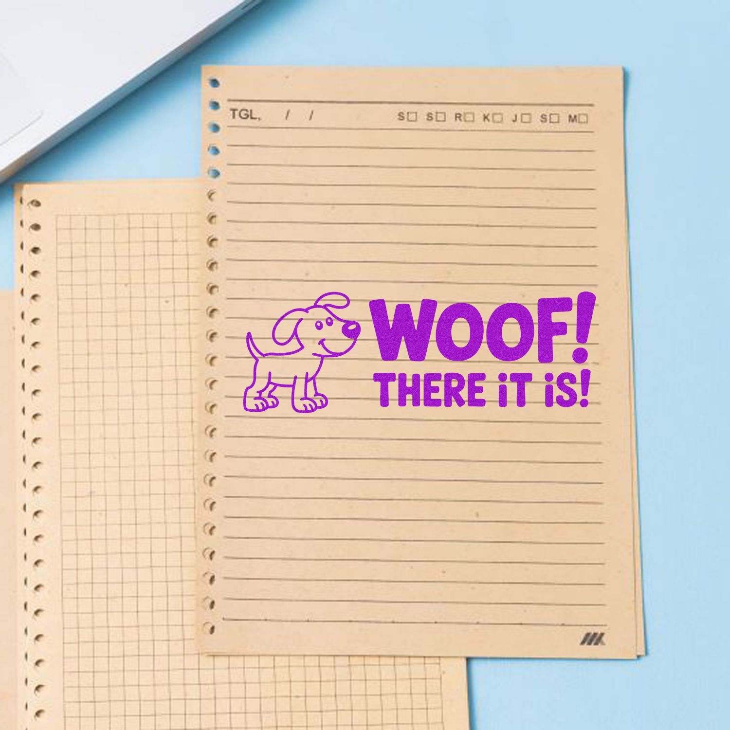 Purple dog rubber stamp with WOOF! THERE IT IS! on notebook paper, ideal for pet-themed custom stamps.