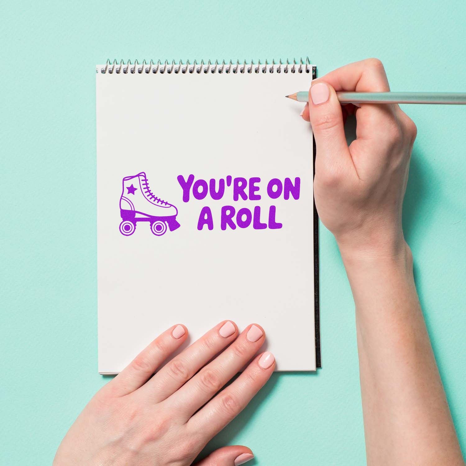 Custom rubber stamp saying Youre on a Roll with roller skate icon, ideal for motivational stationery and crafts.