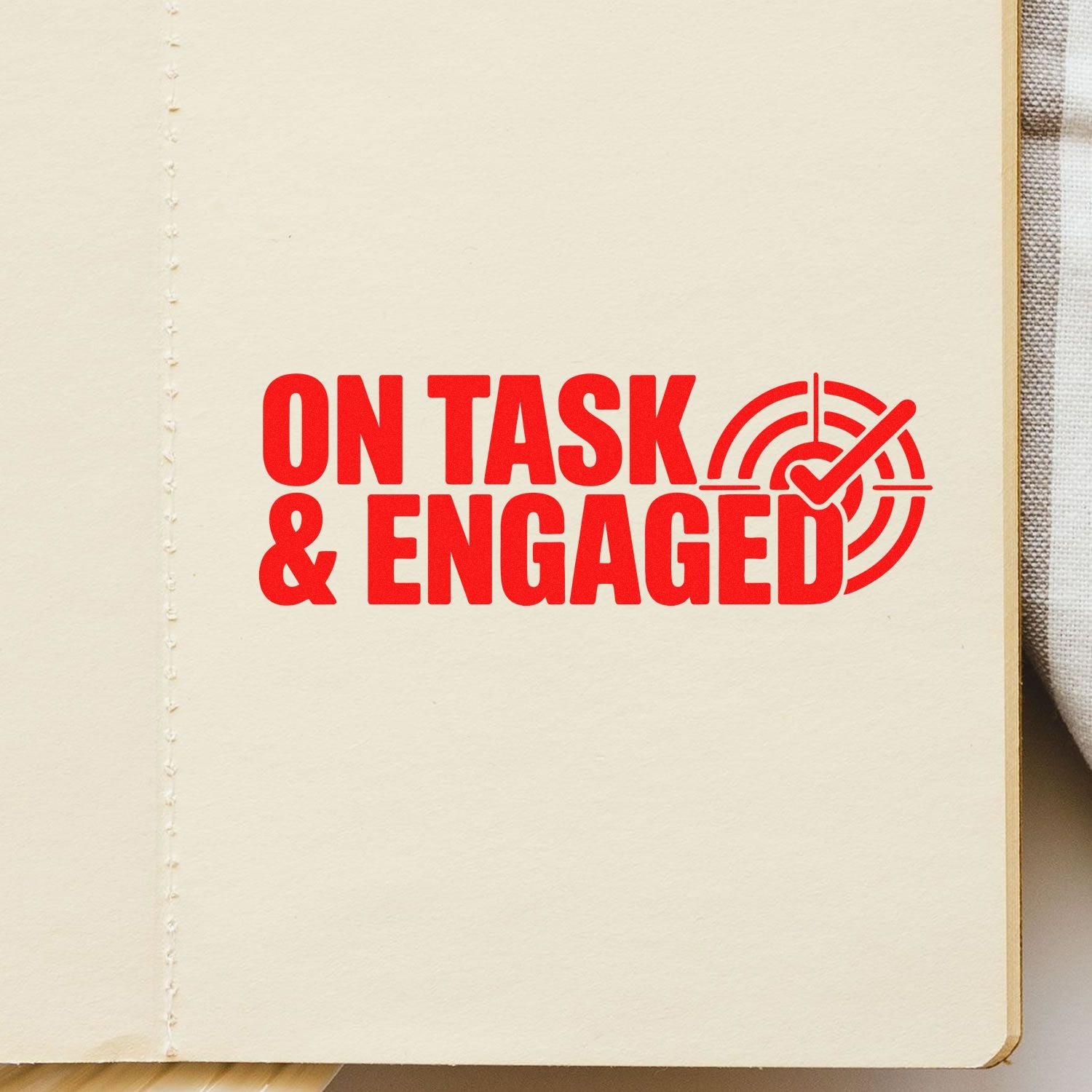 Red On Task & Engaged rubber stamp imprint on notebook page, ideal for teacher feedback, classroom organization, and student work.