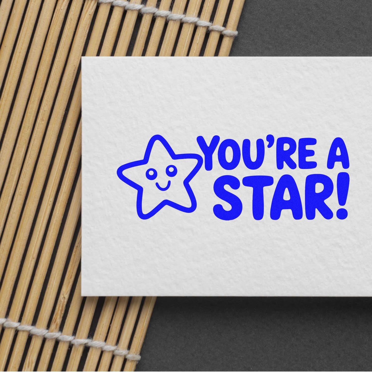 Youre a Star custom rubber stamp with smiling star icon, printed in blue on white paper.