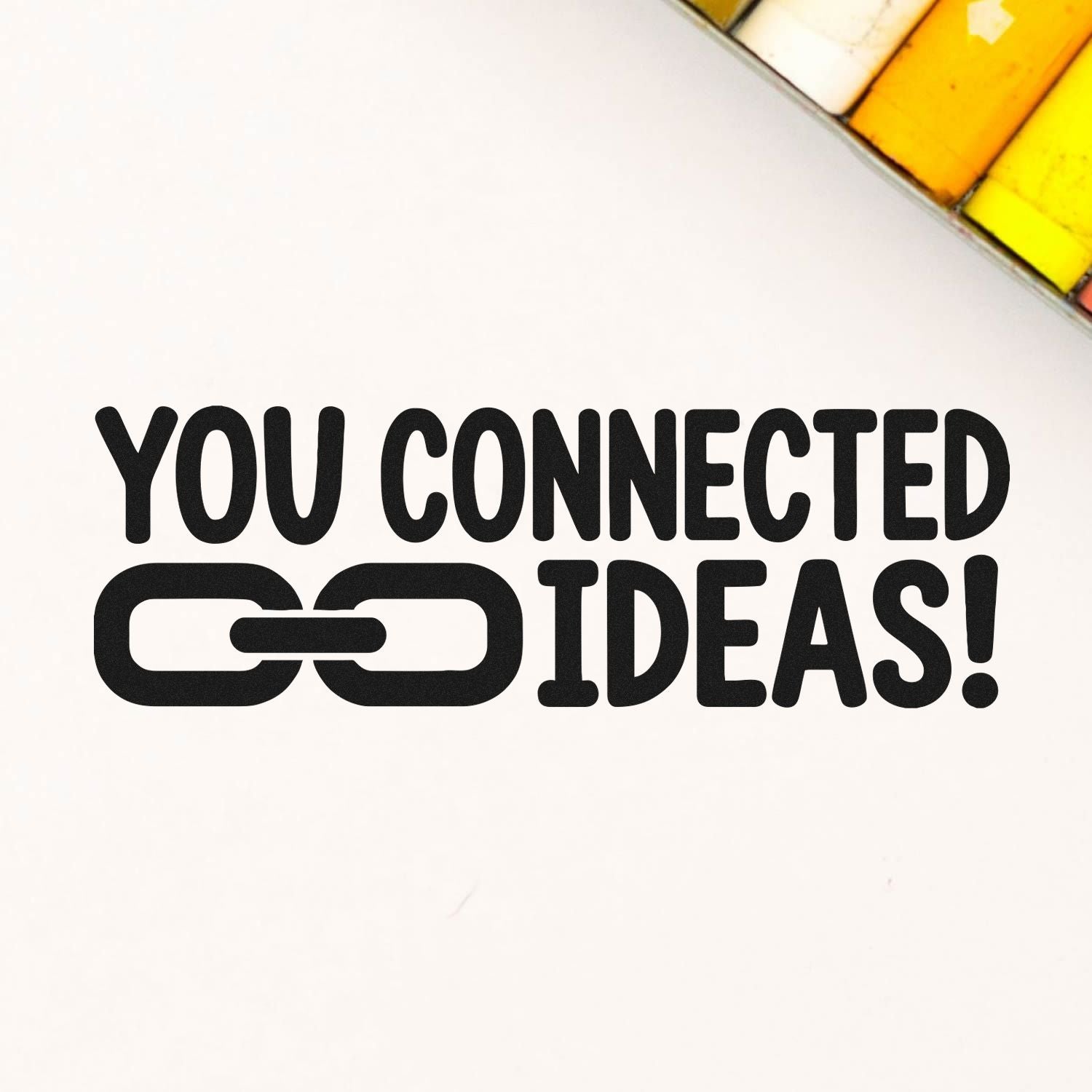 Creative rubber stamp design with chain link icon and You Connected Ideas! text for branding or teamwork messaging.
