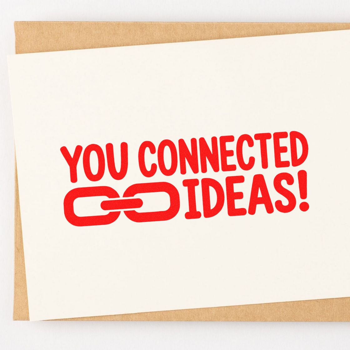 Red rubber stamp design reading You Connected Ideas! with chain-link icon on paper, ideal for creative collaboration branding.
