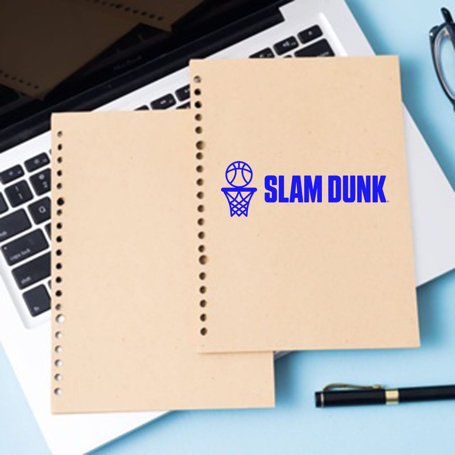 Blue basketball slam dunk rubber stamp on notebook paper, ideal for sports-themed stationery, branding, and custom crafts.