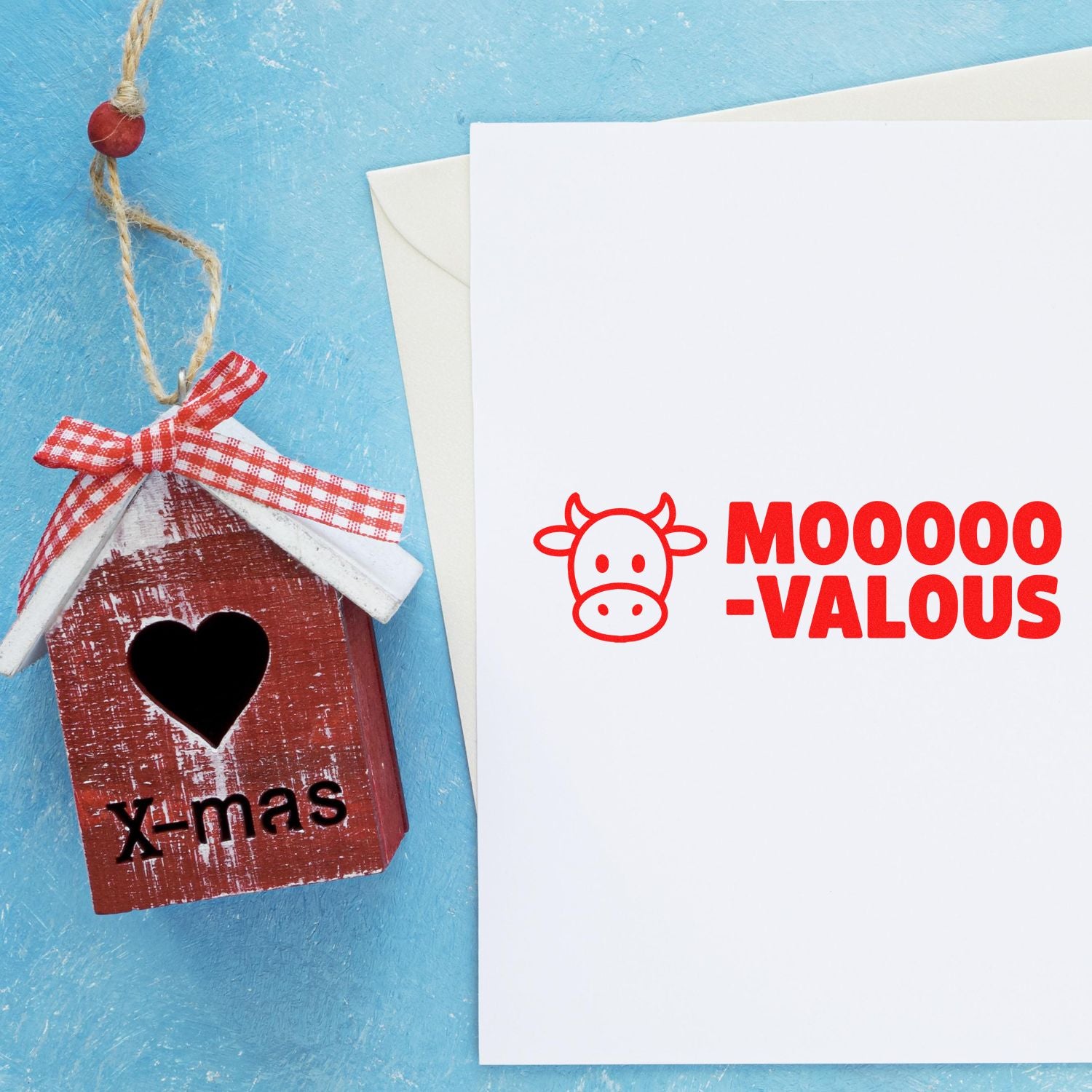 Christmas cow rubber stamp design with Mooo-valous text beside a rustic x-mas barn ornament.