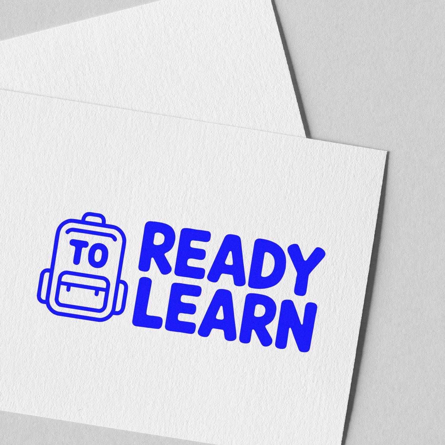 Ready to Learn rubber stamp design with backpack icon, ideal for school supplies, classroom branding, and education.