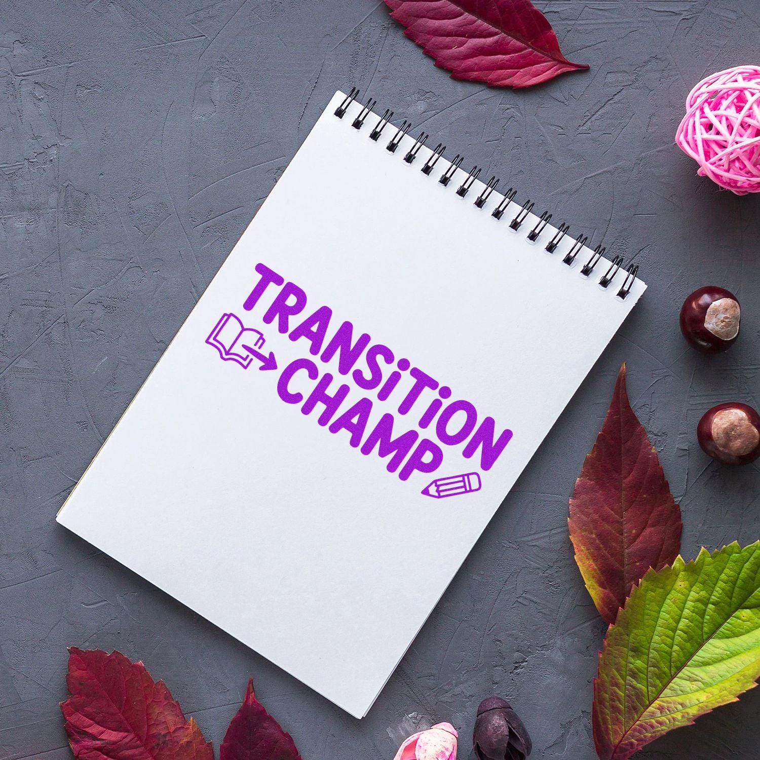 Transition Champ rubber stamp on a notebook, ideal for teacher rewards, classroom motivation, and school transition recognition.