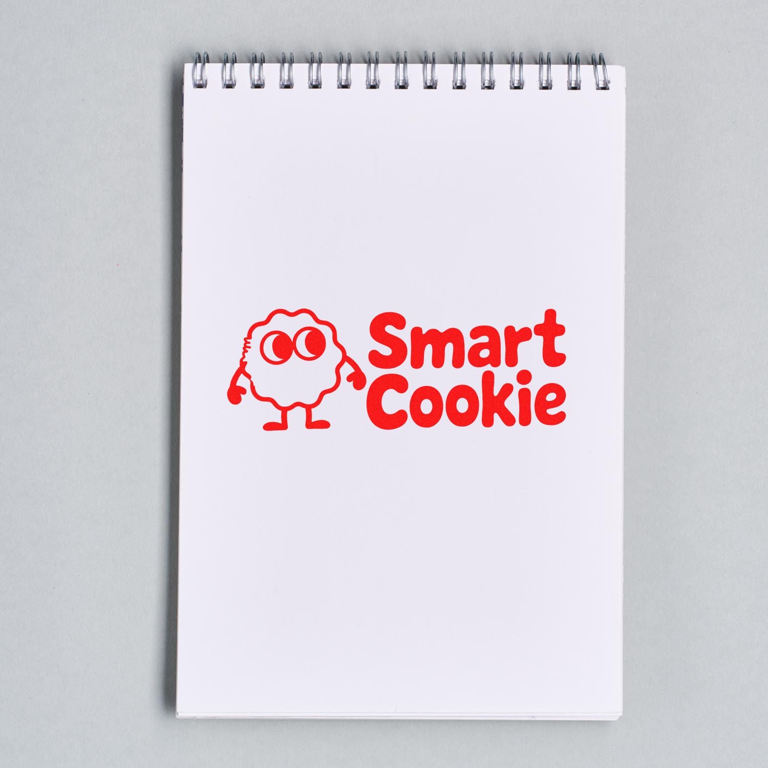 Smart Cookie rubber stamp design with playful cookie mascot on a spiral notebook page.