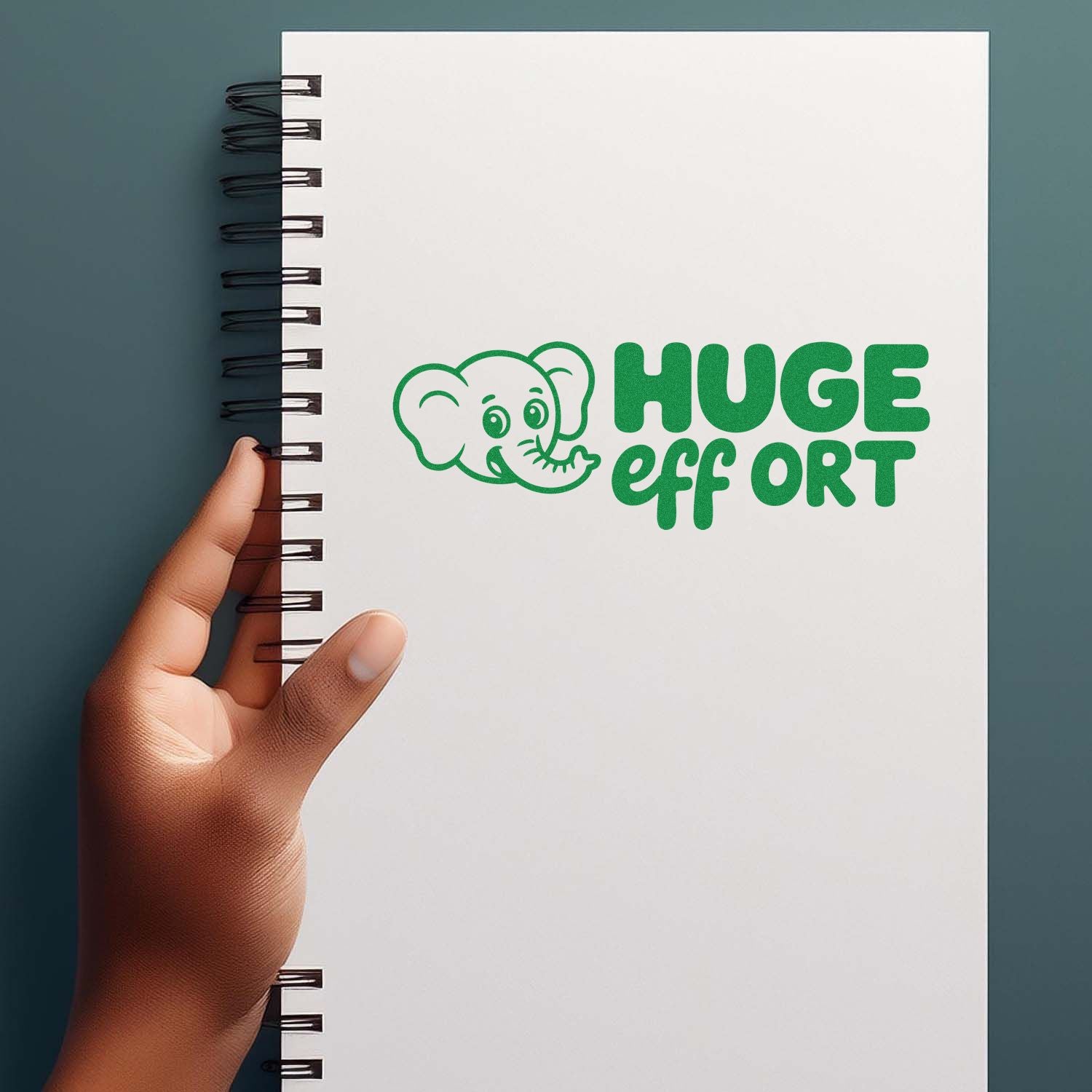 Green elephant HUGE effort rubber stamp on a spiral notebook, ideal for playful motivational office or school feedback.