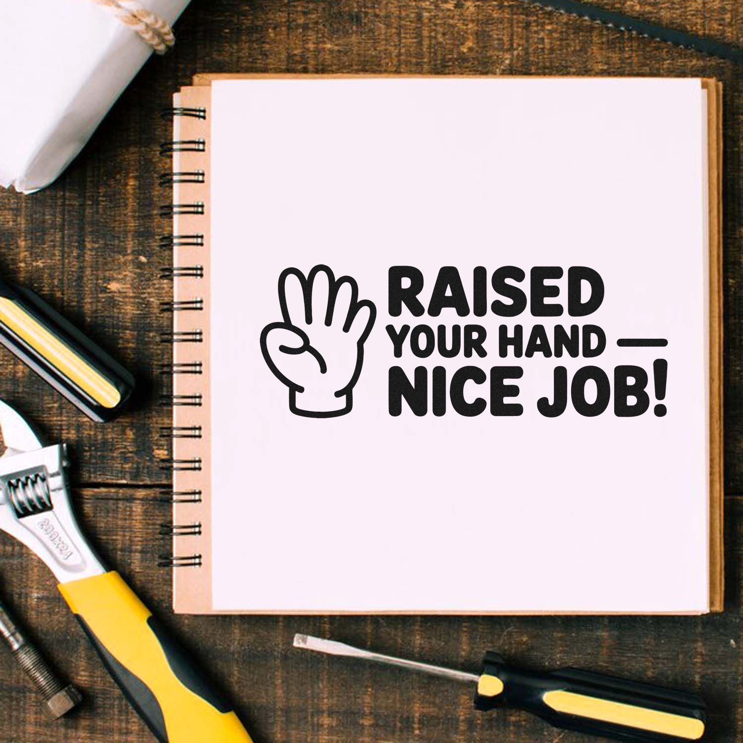 Raised Your Hand Nice Job rubber stamp design on notebook, ideal for classroom rewards and positive student feedback.