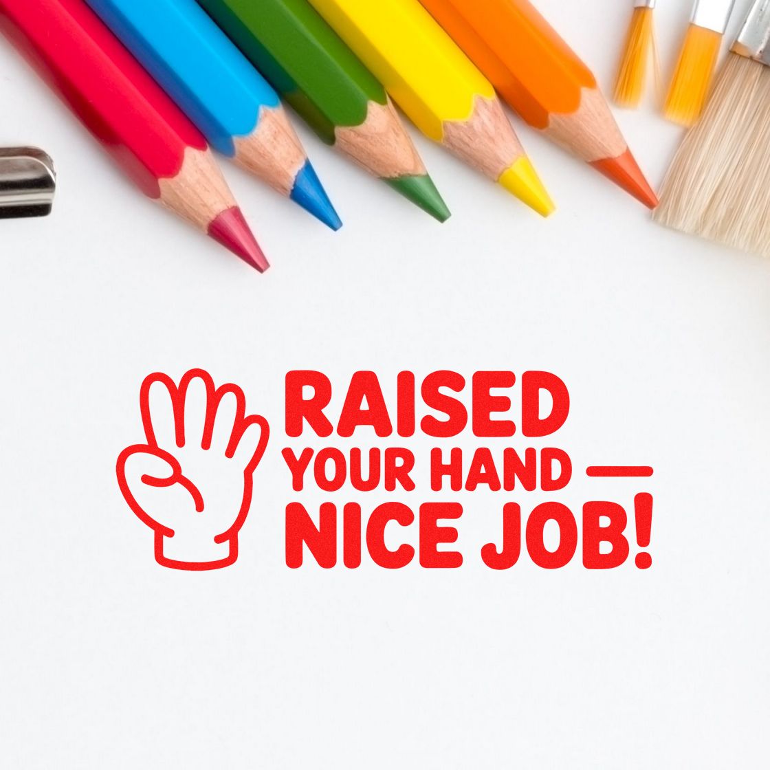 Classroom reward rubber stamp with hand icon and Raised your hand, nice job! message, surrounded by colored pencils.