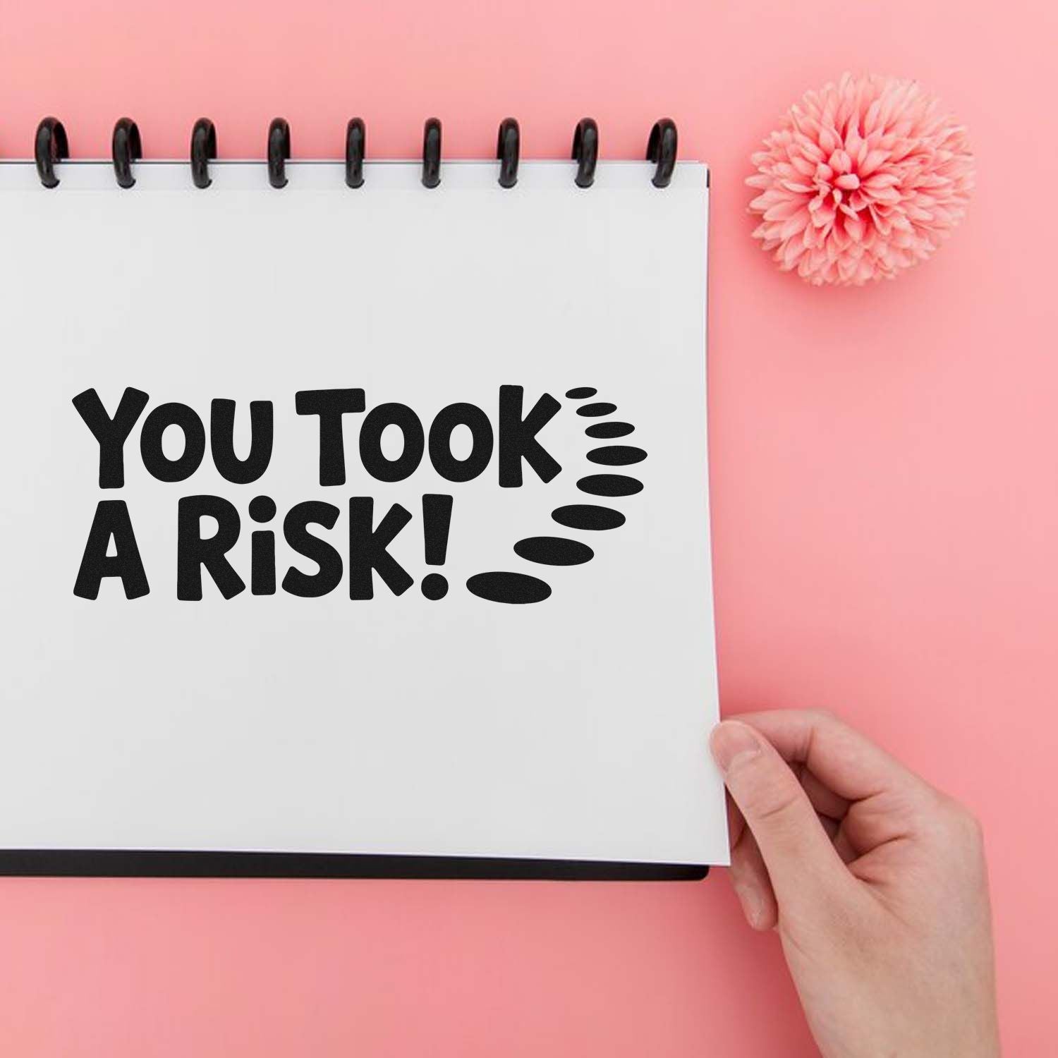 Rubber stamp impression reading You Took a Risk! on notebook page, ideal for bold motivational or warning message stamping.