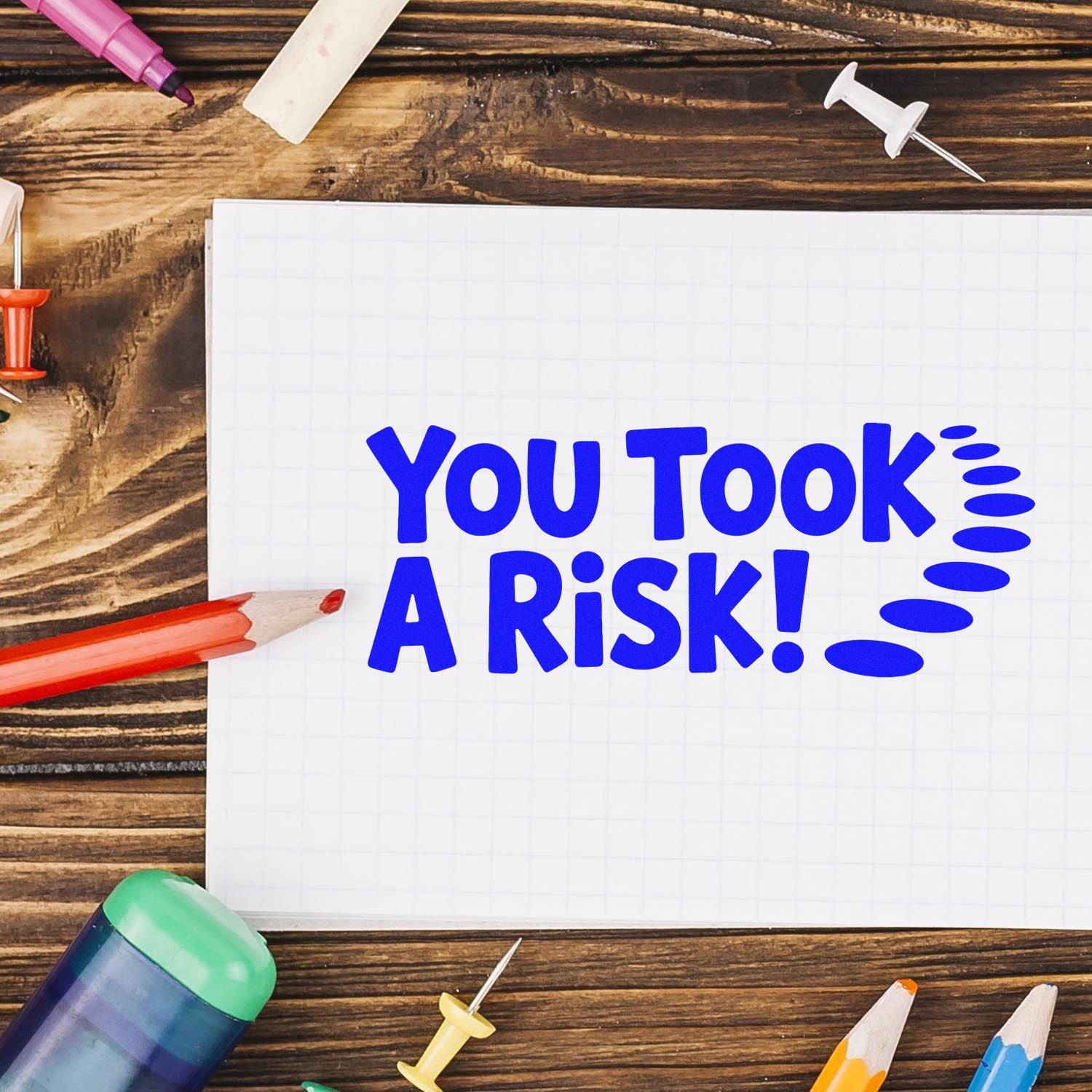 Rubber stamp design reading "You Took a Risk!" on notebook paper with school supplies, ideal for teacher feedback and grading.